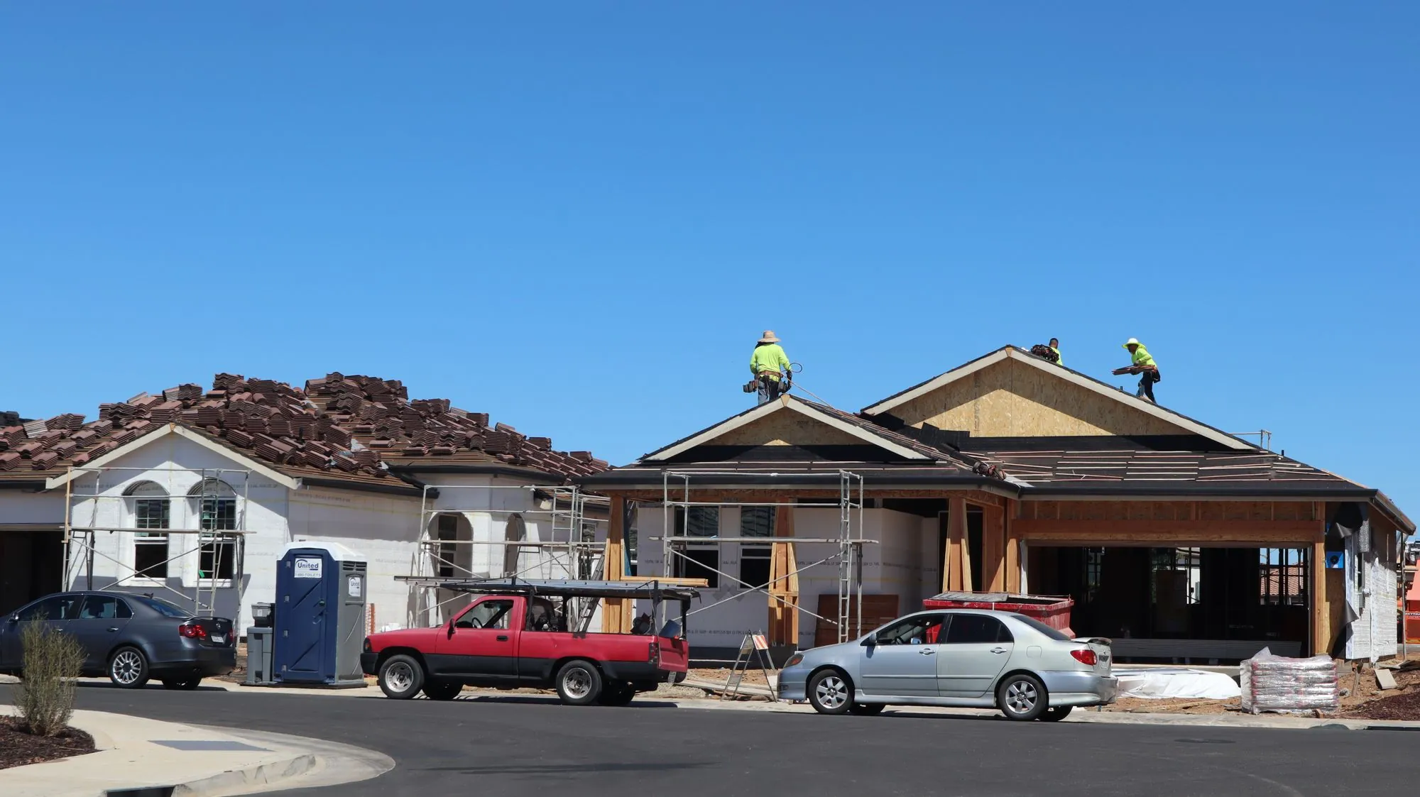 A crew working on the roof of a newly built house