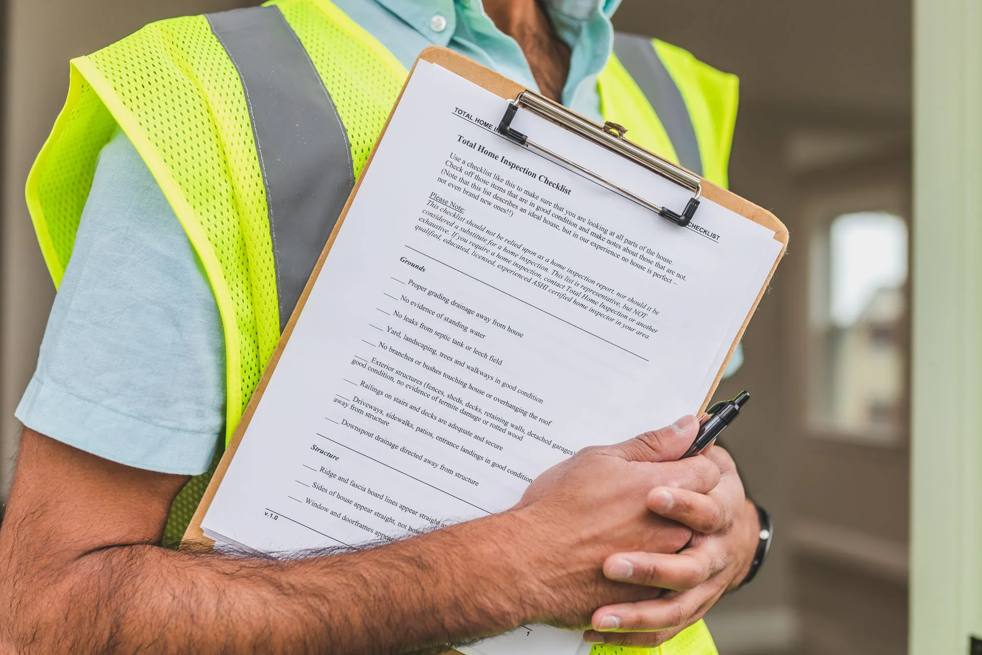 An inspector holding a printed checklist on a clipboard